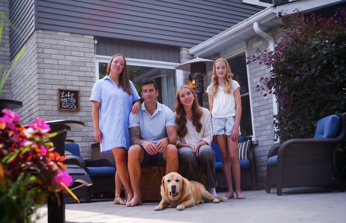 Greg Cox with his family and their dog at home in Guelph